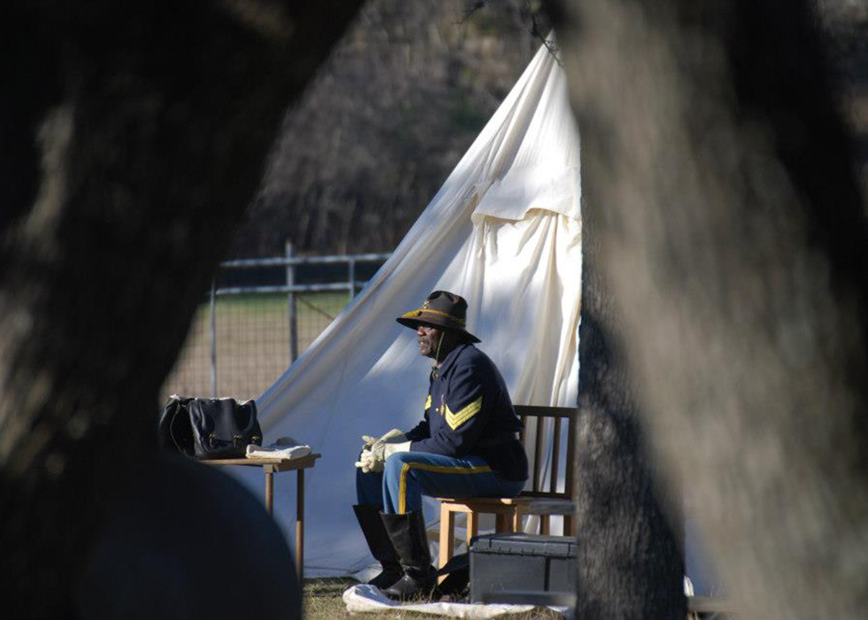 Buffalo Soldiers sitting by camp.