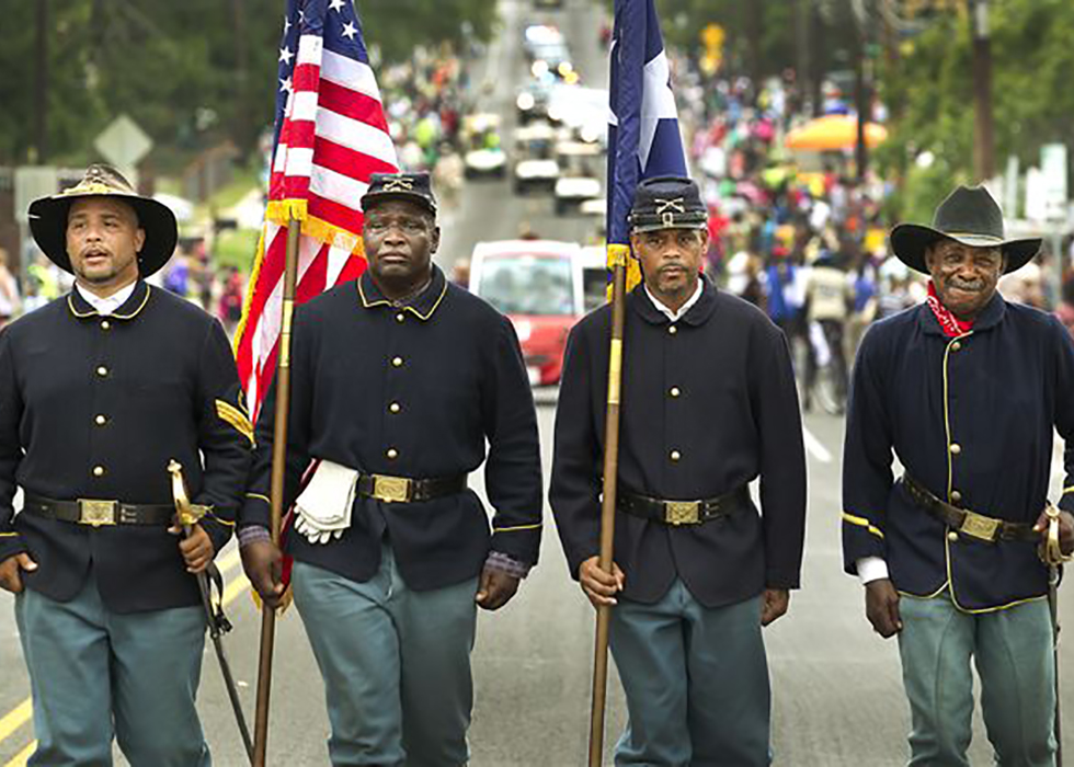 Buffalo Soldiers in uniform in parade.